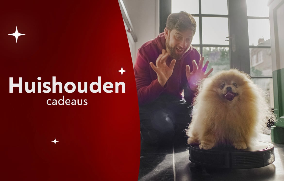 Een man kijkt naar zijn hond die op een robotstofzuiger zit