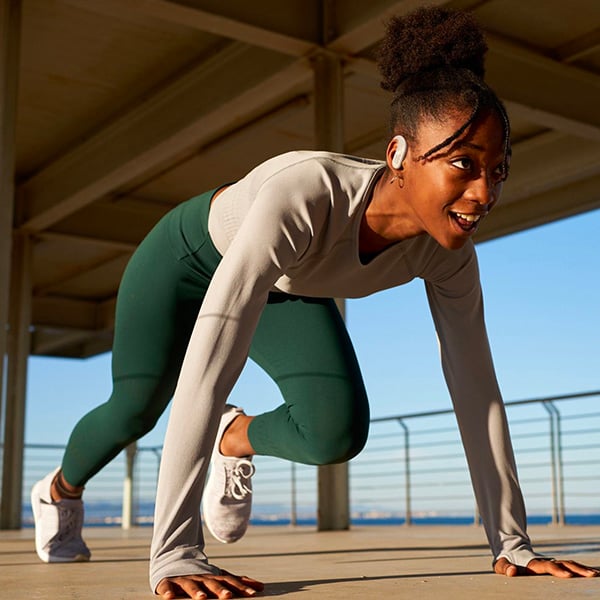 Une femme pratiquant du sport avec ses couteurs sans fil  