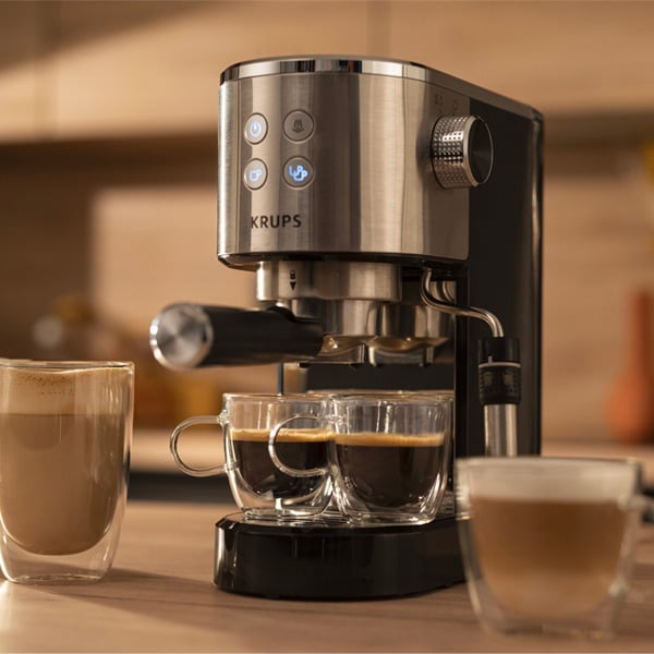 Krups Virtuoso koffiemachine met twee kopjes onder en dan nog een grotere en een middelgrote kop naast het toestel