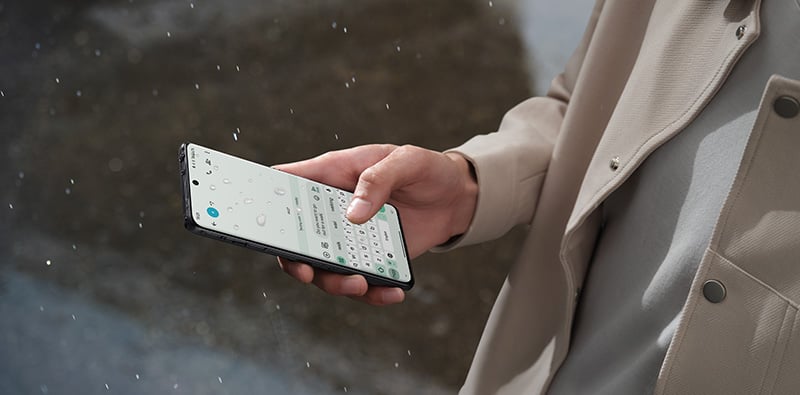 Une personne qui utilise son OnePlus sous la pluie