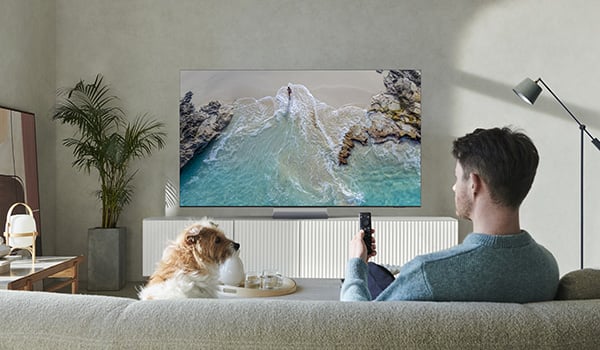 Een Samsung TV met een gele auto omringd door Ambilight.